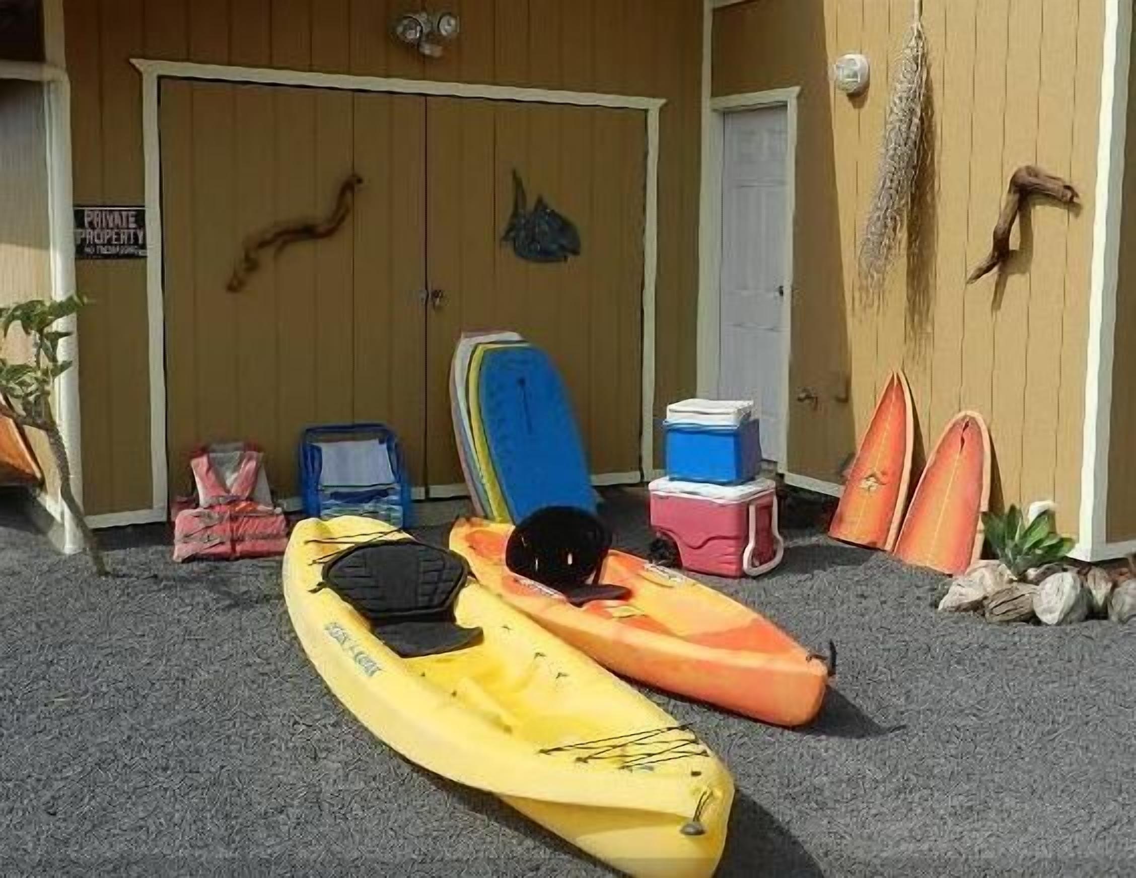 A storage area with kayaks, a cooler, and a 'PRIVATE PROPERTY' sign.