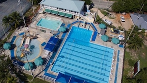 An aerial view of a hotel with multiple swimming pools, a covered area, and a building with a green roof. - Nov 18-Jan 1 Open... Live Like a Local*Waterview*Pet Friendly*Key Largo MM 99.5*Manatees (Key Largo)