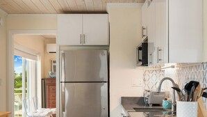 A modern kitchen with a stainless steel refrigerator, a sink, and bar stools. - Nov 18-Jan 1 Open... Live Like a Local*Waterview*Pet Friendly*Key Largo MM 99.5*Manatees (Key Largo)