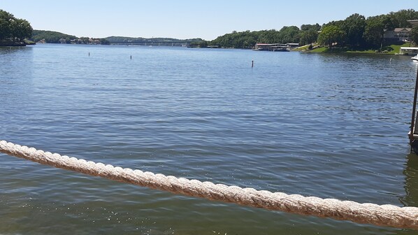 A calm lake with a rope barrier in the foreground.