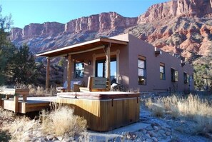 Relax in a serene natural setting with a hot tub and expansive views.