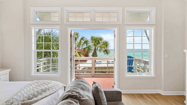 A bedroom with a large window, a bed, and a view of the beach. - Surfin' Sea | 1 PM Check In! | Modern Updated Gulf-Front Home | Private Pool | FREE Beach Chairs Within Steps | 6-Seat Golf Cart Included! | Stunning Views! (Miramar Beach)