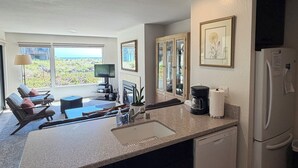 A modern kitchen with a large island, built-in appliances, and a view of the outdoors. - Pajaro Dunes Vacation Home on Epic Private Beach for family or Romantic Getaway (Watsonville)