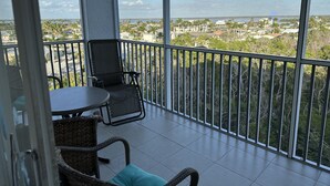A balcony with a view of a cityscape and the ocean. - Upscale Top-Floor Condo W/Gulf View, Sugary Sand Beach (Fort Myers Beach)