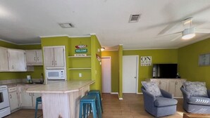 A compact living space with a kitchen, dining area, and seating area. - 2 Bedroom, Across the street from the beach! & Pup-Friendly! (Gulf Shores)