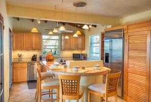Enjoy cooking in this kitchen with a central island and pendant lighting.