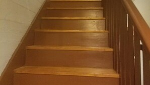 A wooden staircase with a handrail, leading to a door at the top. - VRBO 184287 Book Group trip Late Spring/Summer! We're Booked (Galveston)