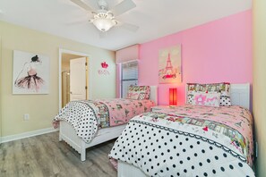 A bedroom with two beds, a ceiling fan, a door, and a window with blinds. - ⭐⭐⭐⭐⭐Oversize Private Pool & Spa, Free Pool Heat, Exclusive Luxury Platinum Home (Davenport)