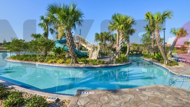 A swimming pool with a water slide, palm trees, and a no entry sign. - ⭐⭐⭐⭐⭐Oversize Private Pool & Spa, Free Pool Heat, Exclusive Luxury Platinum Home (Davenport)