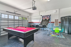 A pool table with balls, a billiards table, a basketball hoop, and a seating area with chairs and a table. - ⭐⭐⭐⭐⭐Oversize Private Pool & Spa, Free Pool Heat, Exclusive Luxury Platinum Home (Davenport)