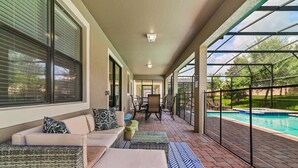 A covered patio with a pool, outdoor seating, and a view of the backyard. - ⭐⭐⭐⭐⭐Oversize Private Pool & Spa, Free Pool Heat, Exclusive Luxury Platinum Home (Davenport)