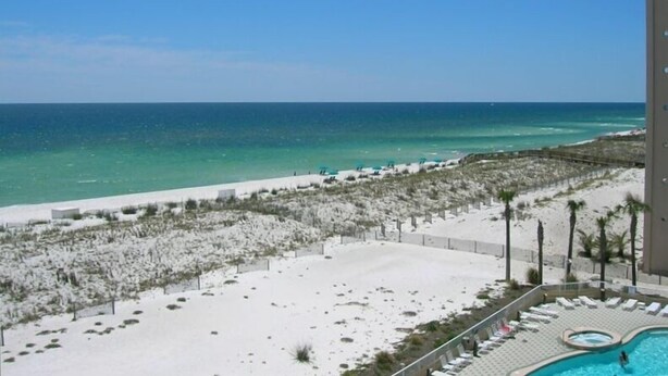 A resort with a pool, beach, and ocean view. - FREE Beach Chairs, GULF FRONT, Common Pool/Hot Tub, VIEWS!, Wrap around balcony (Navarre)