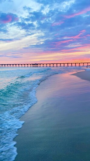 A beach with a pier extending into the water. - Calypso 101 West-DESIRABLE 1stFloor-2 KingBeds!-Sleeps6-HeatedPool-ADA BeachRamp (Panama City Beach)