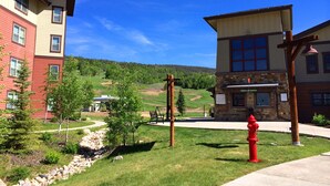 A building with a stone facade and a red fire hydrant in front.