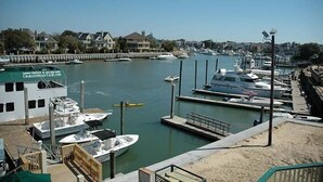 A marina with boats docked, a building labeled "Charleston Yacht Club," and a clear view of the water and surrounding area.