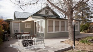 A house with a covered patio, outdoor seating, and a fire pit.