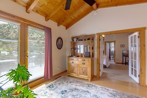 A room with a wooden ceiling, a wooden cabinet with drawers, a mirror, and a door leading to another room. - Large 4 bed, 2 bath luxury home, views, patios for up to 8 guests (Bisbee)