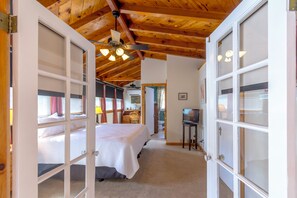 A bedroom with a bed, a desk, and a television. - Large 4 bed, 2 bath luxury home, views, patios for up to 8 guests (Bisbee)