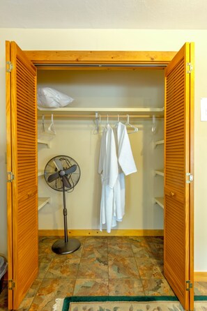 A walk-in closet with a fan, hanging clothes, and a tiled floor. - Large 4 bed, 2 bath luxury home, views, patios for up to 8 guests (Bisbee)