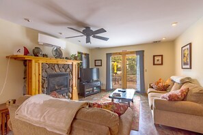 A living room with a fireplace, television, and seating area.