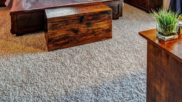 A bedroom with a bed, a wooden nightstand, a dresser, a mirror, a ceiling fan, and a window with curtains. - Endless Tucson Desert Views 3Br2Ba Home 2 Acres Garage Arcade Games Nature Oasis (Tucson)