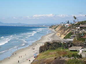 A coastal beach with a sandy shore, waves, and a clear sky. - 2-blocks to Moonlight Beach, Private Yard, AC,  bikes, Over 300 5-star reviews (Encinitas)