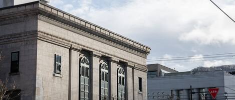 A building with large windows and a stone facade.