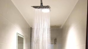 A modern bathroom with a shower, toilet, and sink. - Miri Budget Inn (Miri)