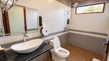 A bathroom with a sink, toilet, and shower.
