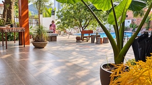 A spacious outdoor area with a pool, seating, and potted plants. - Ninh Binh Greenland Homestay (Hoa Lu)