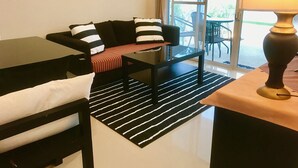 A modern living room with a sofa, a coffee table, and a lamp. - 2 Bedroom Luxury House near Beach SDV002 By Samui Dream Villas (Koh Samui)