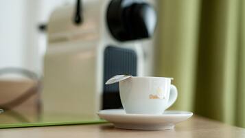 A white cup with a lid on a saucer, placed on a table with a green placemat.