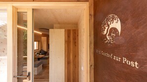 A wooden interior with a staircase leading to a seating area.