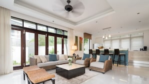 A spacious living room with a sofa set, a coffee table, and a dining area with bar stools. - 2 Br Luxury Villa SDV141 near the beachfront by Samui Dream Villas  (Koh Samui)