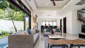 A modern living room with a sofa, coffee table, and a dining area with chairs. - 2 Br Luxury Villa SDV141 near the beachfront by Samui Dream Villas  (Koh Samui)