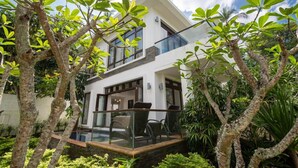A modern two-story house with a glass balcony, surrounded by lush greenery. - 2 Br Luxury Villa SDV141 near the beachfront by Samui Dream Villas  (Koh Samui)