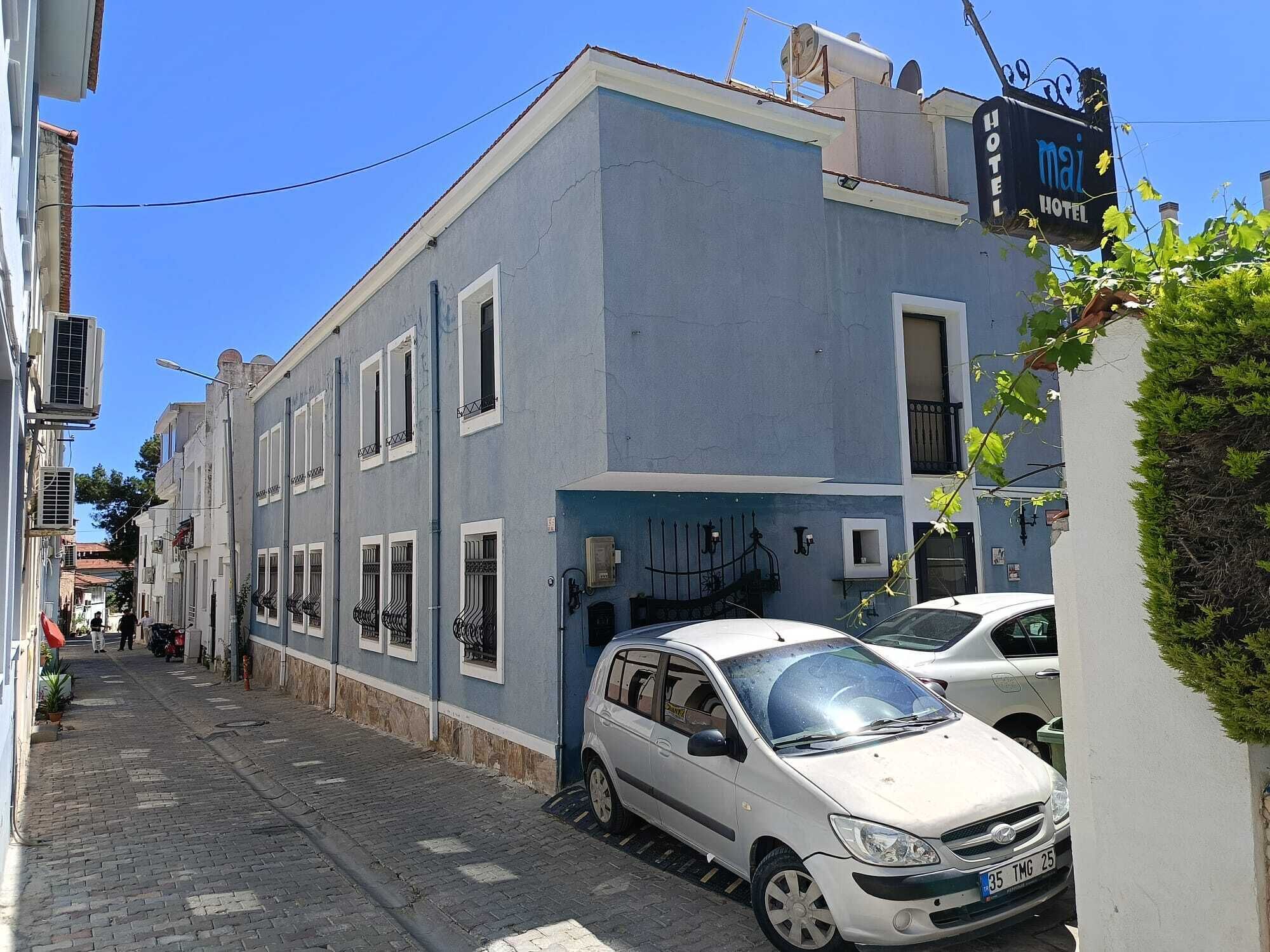A narrow street with a building labeled 'MAZ HOTEL' on the right.