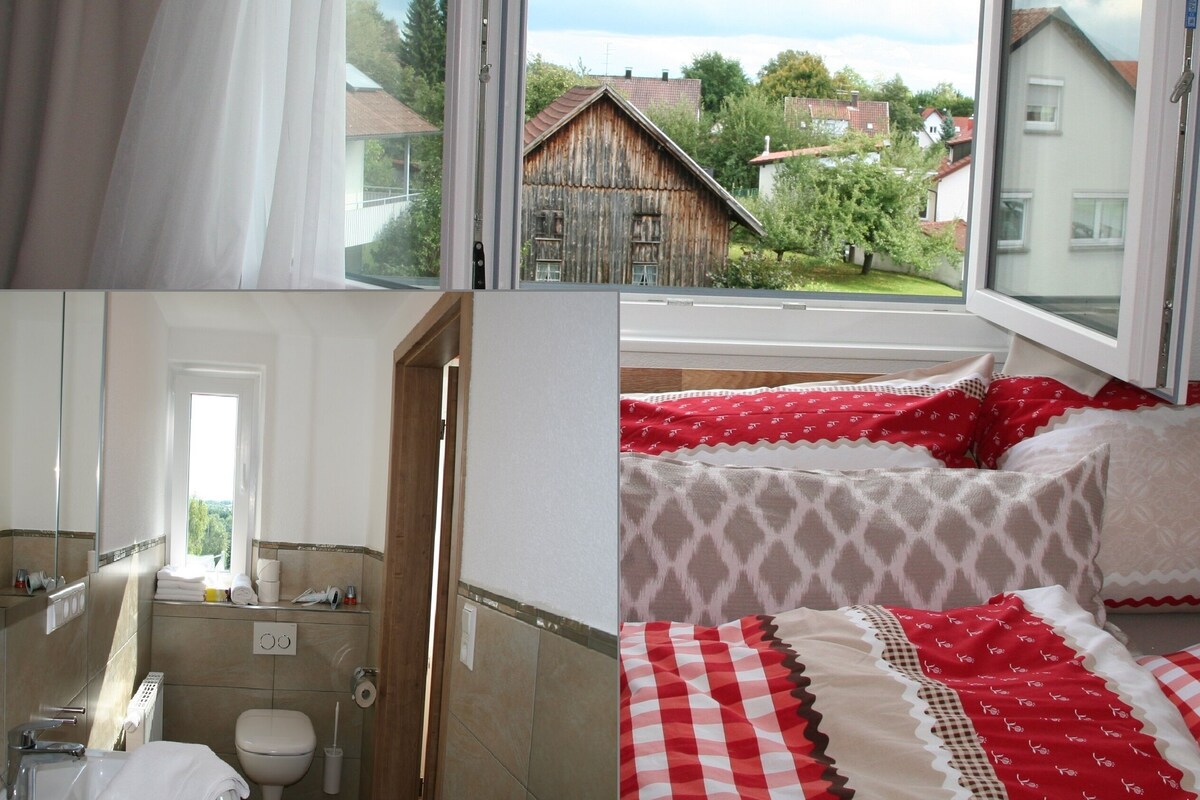 A bathroom with a bathtub, toilet, and towel rack.