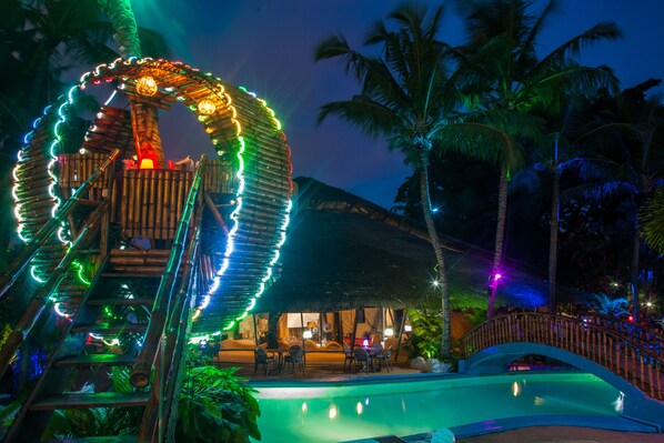 Een buitenzwembad, parasols bij het zwembad en ligstoelen