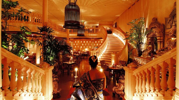 A grand hotel lobby with a staircase, ornate decor, and multiple dining areas. - Astoria Lucerne (Lucerne)