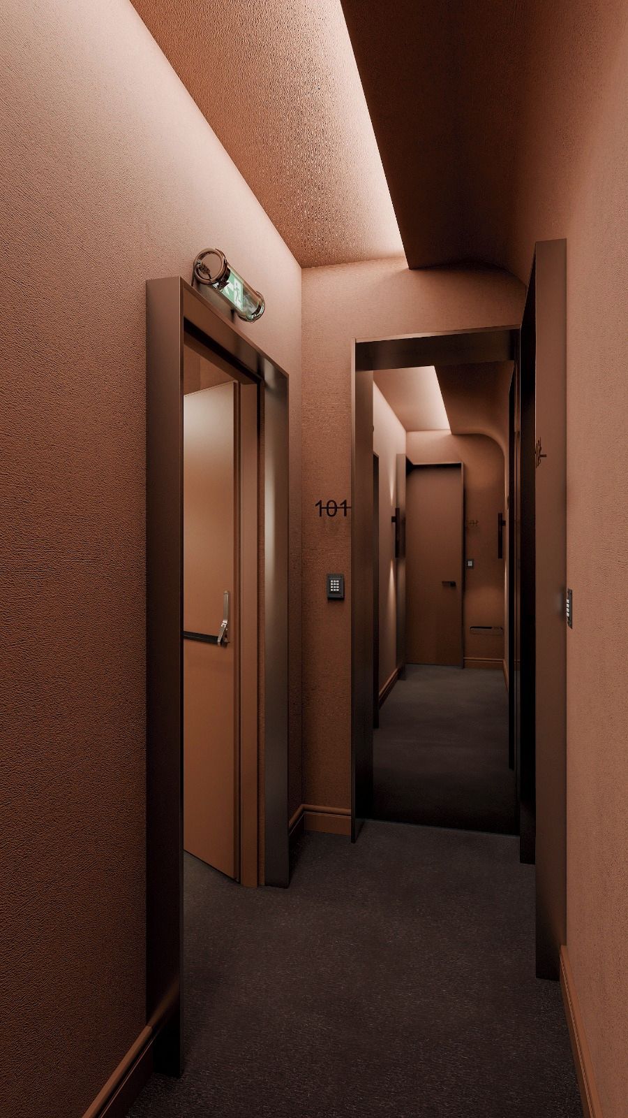 Un couloir doté d’un sol recouvert de moquette, une porte portant le numéro « 101 », et un luminaire fixé au mur.