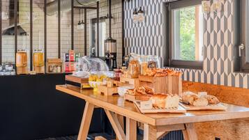 A breakfast buffet with various food items and a coffee station.