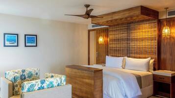 Una habitación de hotel con cama, escritorio, silla y ventilador de techo.