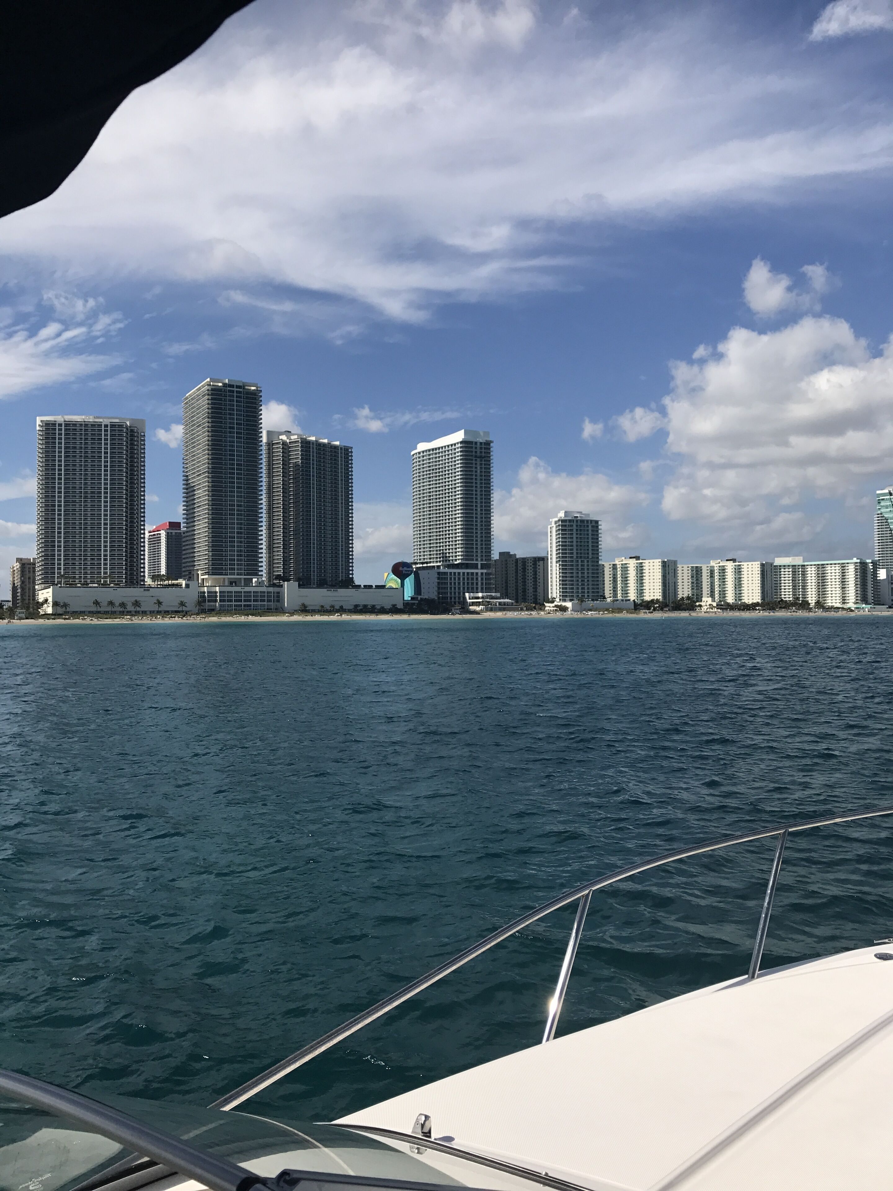 A view of a marina with several high-rise buildings in the background.