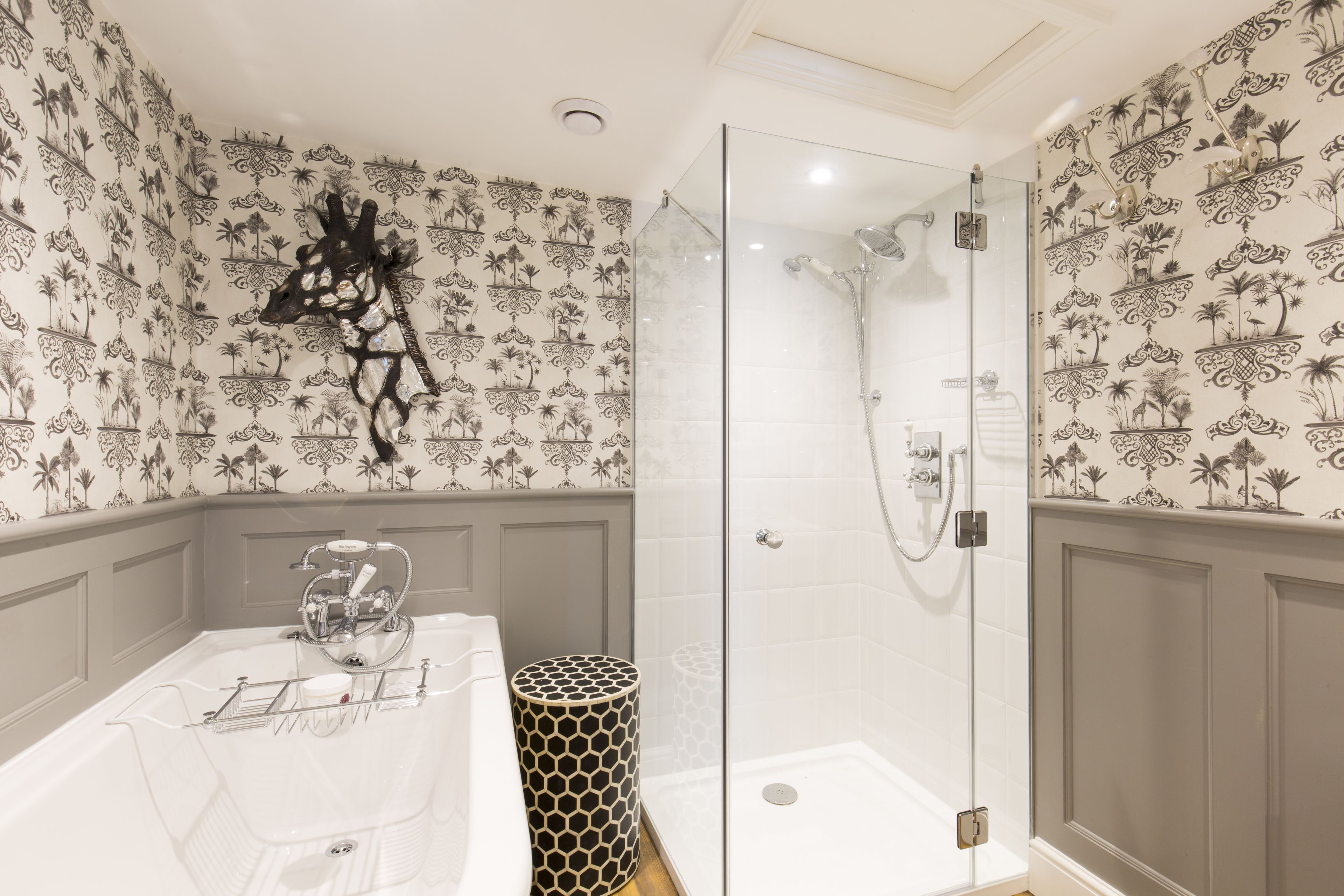 A bathroom with a shower, a bathtub, and a toilet.