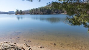 A calm lake with a rocky shoreline and trees in the background. - Mountain Air Cabin near Franklin, Cashiers and Highlands, North Carolina (Franklin)