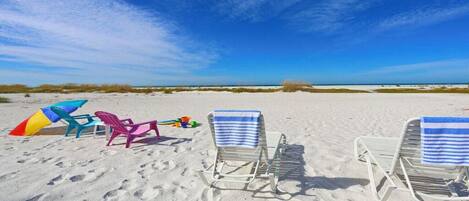 On the beach, sun loungers, beach towels