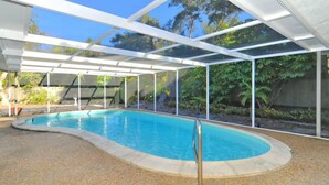 A covered swimming pool with a clear view of the surrounding garden and trees. - #1 SIESTA KEY Beach Glass House w/supplies
 PRICE Breaks w/ 3 payments ! (Siesta Key)