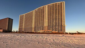 A large hotel with multiple floors and balconies, situated on a sandy beach. -  Spectacular 5th floor Direct Oceanfront - lots of amenities!!- sleeps up to 7 (Panama City Beach)