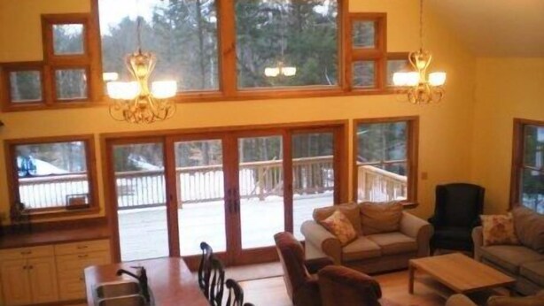 A spacious living area with a large dining table, multiple sofas, and a fireplace. - Stratton, Okemo, Bromley, Viking Nordic XC, Skiing!! (Londonderry)